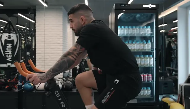 Ilia Topuria on an assault bike in his gym